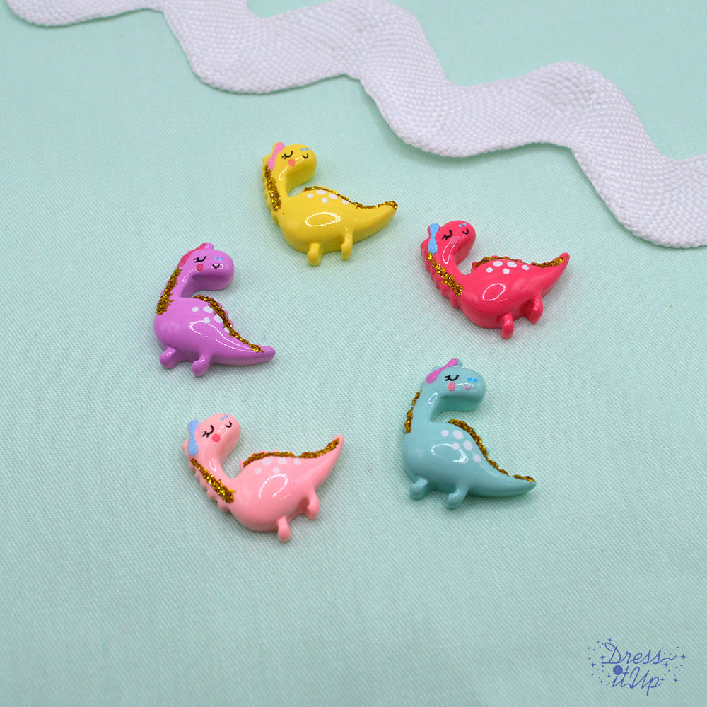 5 flat-back button embellishments pack with pink, purple, blue, magenta, yellow, gold glitter dinosaurs