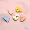 Backs of 5 flat-back button embellishments pack with garden flowers, tulips, bluebells, daisies, primrose, yellow begonias