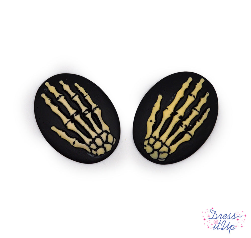 2 flat-back button embellishments pack with skeleton hands on black cabochons