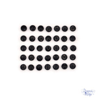 6mm round black buttons on a white background. Buttons made for sewing projects. 