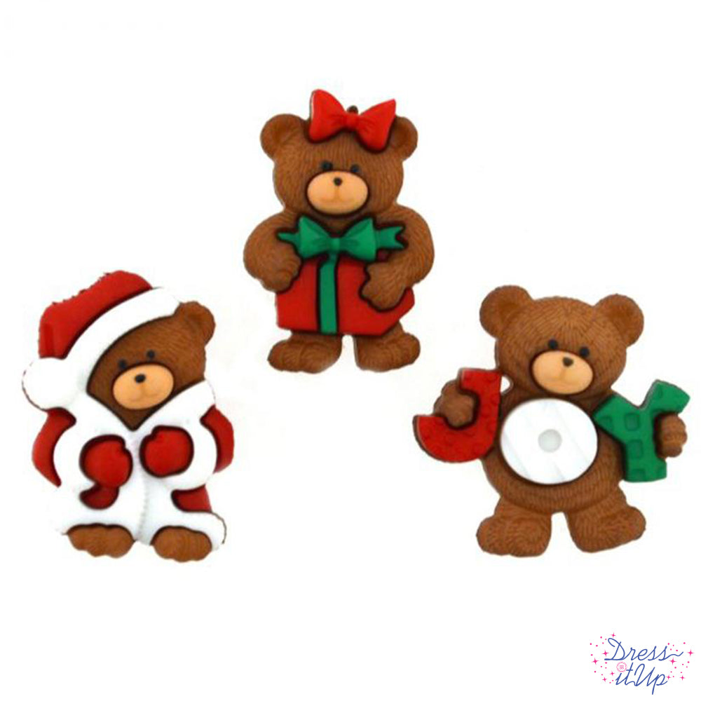 Three shank-back Christmas bear buttons pack under a Christmas tree with a Santa costume, a present, and a joy sign